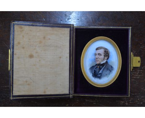 A Victorian oval miniature portrait on glass of a gentleman with sideburns, in leather pocket-case