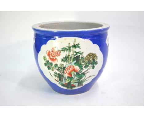 A Chinese, powder-blue ground planter or small fish bowl; decorated with shaped panels of floral arrangements and scholar's i