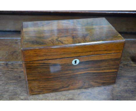 A late 19th century rosewood tea caddy with mother of pearl escutcheon, the interior with lidded compartment and moulded glas