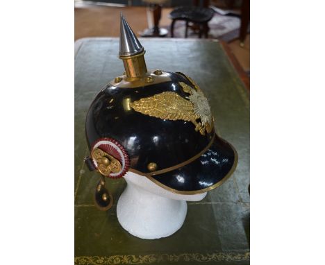 A reproduction WWI pattern German helmet with screw-in spike and liner