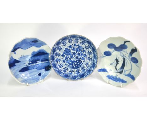 A Chinese blue and white plate decorated with floral and plant designs, 22 cm diameter, Kangxi; together with two Japanese so