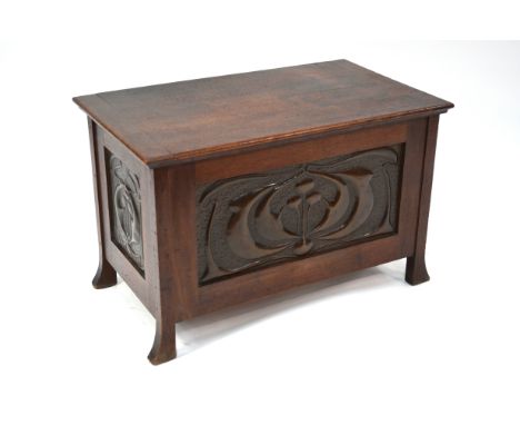 An Arts &amp; Crafts period walnut small coffer/trunk, of jointed construction with relief decorated copper panels in the Lib