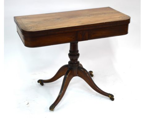 A Regency mahogany card table, the fold over top with baize lining over a storage well and frieze with inlaid decoration, rai