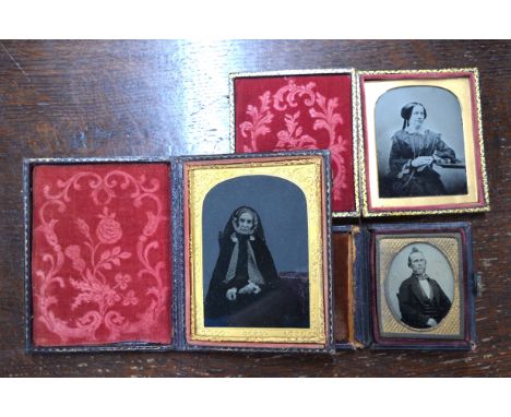 A mid 19th century photograph of an old lady, to/w an Ambrotype of a younger woman and a small oval portrait of a man, all in