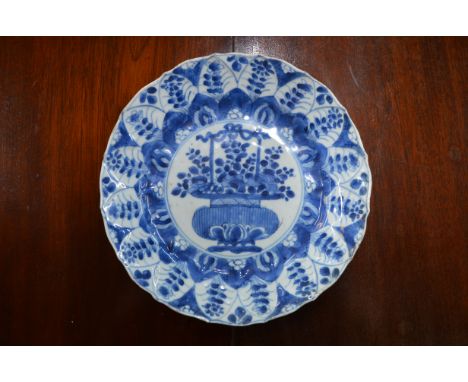A Chinese blue and white dish, decorated with a central panel of a flower arrangement, &nbsp;20.5 cm diameter, Kangxi

Proven