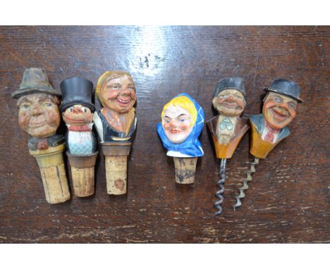 Two Black Forest painted wood figural corkscrews, to/w three somewhat similar stoppers and a ceramic stopper (6)