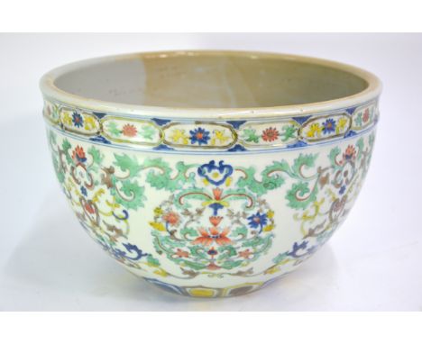 A Doucai planter with unglazed base, decorated in underglaze blue and colours depicting floral and scrolling designs; 27 cm d