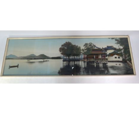 A Japanese textile picture of a lakeside landscape, post Meiji Period, framed and glazed. Overall dimensions about 135 x 42.5