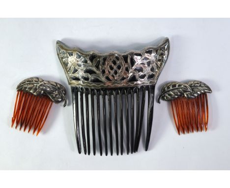 A pair of small hair combs having applied overlapping stylised leaves, stamped sterling to/w hair comb having applied silver 