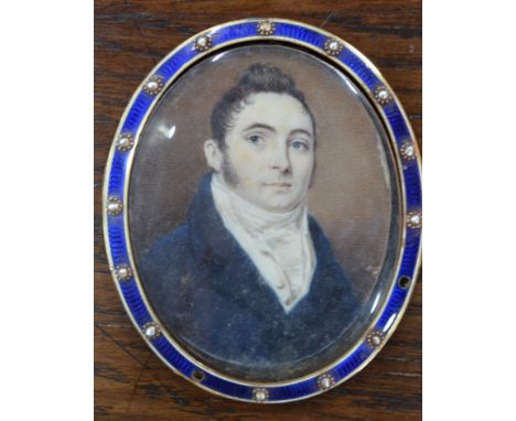 An oval portrait miniature on ivory of a young Regency gentleman with blue coat and high neckcloth, in incomplete gilt metal 