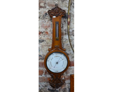 A Victorian oak balloon barometer with ceramic register dial beneath a brass thermometer, 82 cm high