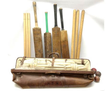 A Vintage leather cricket bag and equipment, to include cricket bats, balls, wickets, and pads. 