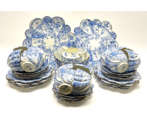 An Edwardian Chapman teaset, of lobed form decorated with blue transfer printed foliate decoration, comprising twelve cups, t