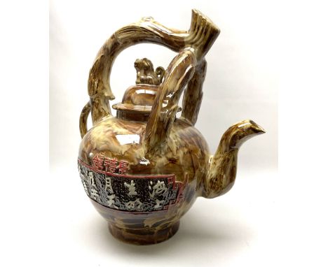 A large novelty Chinese ceramic teapot, the body decorated with characters upon a mottled brown ground, with naturalistically