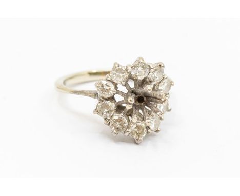 A diamond 18ct white gold cluster ring, with round brilliant cut diamonds, (the central stone missing) total diamond weight a