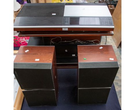 A Bang &amp; Olufsen stereo system; including matching stainless and mahogany unit, records player, CD, tape deck, radio and 