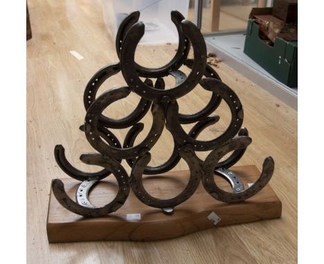 Collection of walking sticks in stick stand along with horse shoe wine/bottle rack