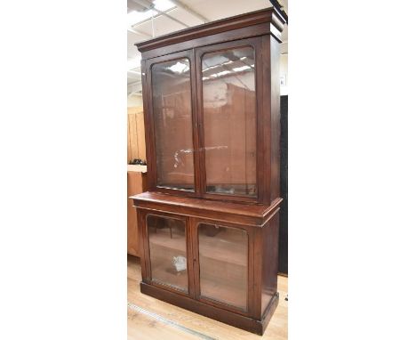 A tall mahogany Victorian display cabinet having top glazed unit with shelves above glazed base with single shelf