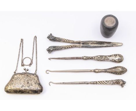 A collection of silver to include: monogrammed purse, three button hooks and glove stretcher, and a novelty gear stick cover,