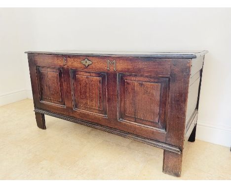 A Georgian oak blanket chest with three panels to the front and large original brass key escutcheon and original lock Initial