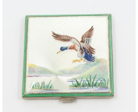 An early 20th Century silver engine turned compact, the enamel cover painted with a Duck landing within river landscape, hall