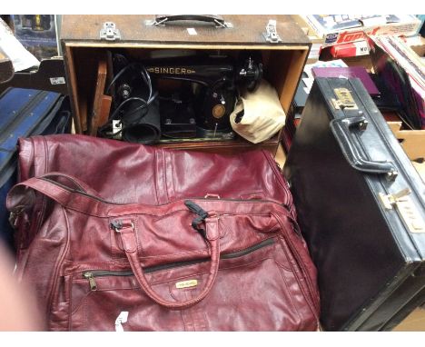 A mid 20th Century Singer sewing machine, in case, electric table top, along with briefcase and two travel cases