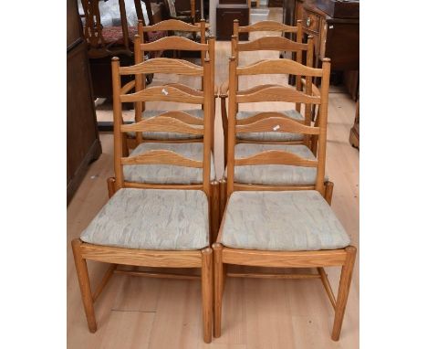 A set of six Ercol chairs, including two carvers, along with a small tripod table