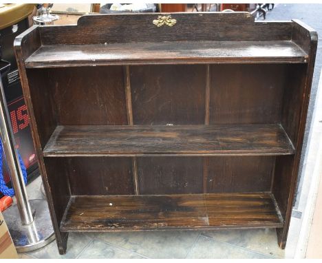 A mid 20th Century darkwood three shelf bookcase along with a mid 20th Century French style lounge chair