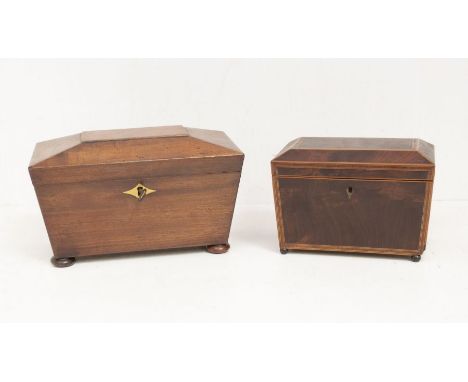 A Regency inlaid mahogany sarcophagus shaped tea caddy, the interior with two lidded compartments, on four bun feet, 19cm lon