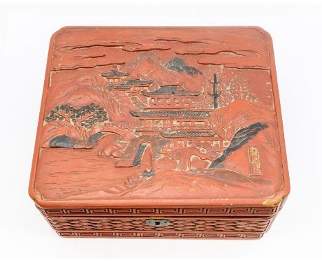 A carved wooden box depicting Japanese landscape, containing a collection of costume jewellery to include a carved cameo broo