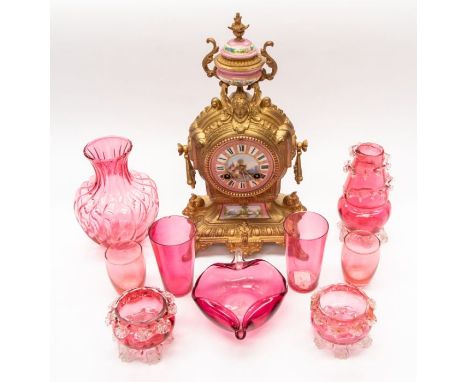 Nine pieces of cranberry glass and French gilt, with a porcelain mantle clock (10)