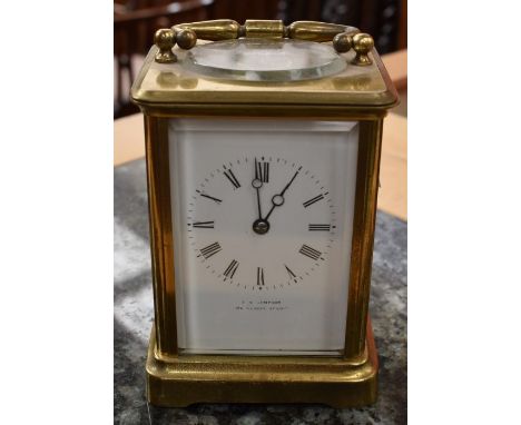 An early 20th Century giltmetal carriage clock, white enamel dial with Roman numerals, retailed by T A Simpson, 154 Regent St