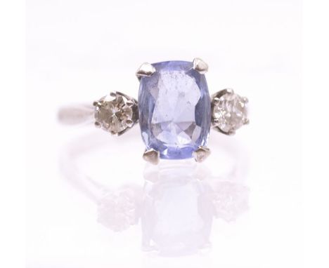 A sapphire and diamond three stone 18ct white gold ring, comprising a claw set cushion cut pale blue sapphire approx 9 x 7mm,