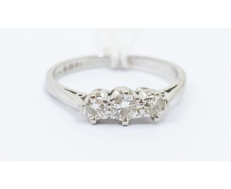 A diamond and platinum three stone ring, comprising claw set round brilliant cut diamonds, with a total diamond weight approx