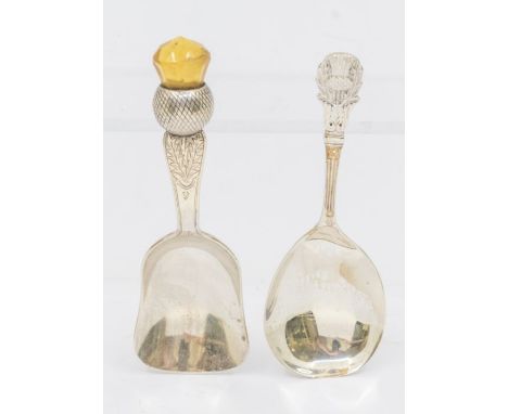 An Arts &amp; Crafts silver thistle shaped caddy spoon, the handle with bright-cut decoration terminating with facet cut citr