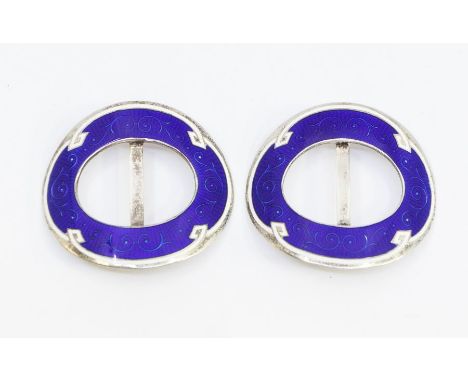 A pair of early 20th century silver and enamel buckles, oval form with blue guilloche enamel within a border of white enamel,