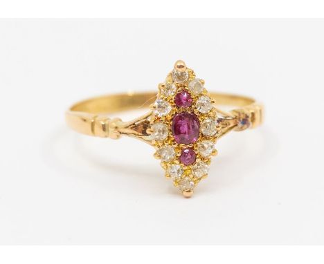 A Victorian ruby and 18ct gold ring, comprising a marquise shaped setting, set with three rubies to the centre within a borde