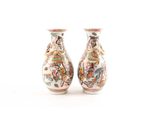 A pair of Chinese Canton enamel vases, second half 19th century, the shoulders with applied gilt chilong above a band of thre