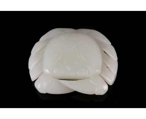 A Chinese white jade carved crab pendant, 20th century, the shell carved with a hatched lozenge framed by scrolls, 5.3cm dia