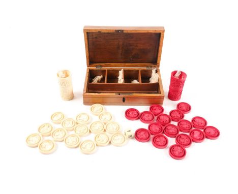 A Chinese carved ivory backgammon set comprising: red and white counters and dice tumblers. Late Qing dynasty. Each counter c
