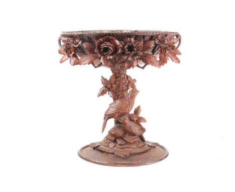 A 19th century Black Forest carved centrepiece, the pierced oval bowl with zinc liner, carved with blossoming flowers and lea