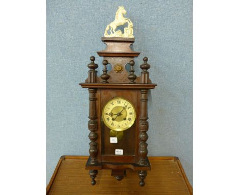 A wall clock with pendulum and key