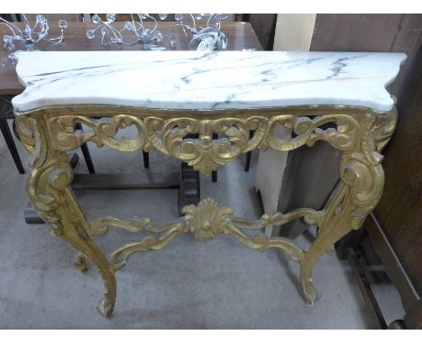 A French Louis XV style carved giltwood and marble topped console table