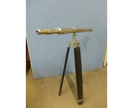 A steel telescope on a tripod stand