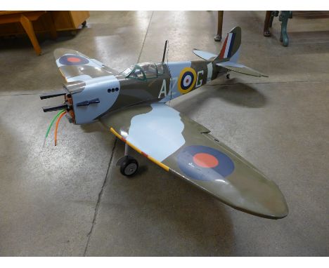 A large remote control model Spitfire with purpose built stand/box containing related parts and Ming Yang multi function pane