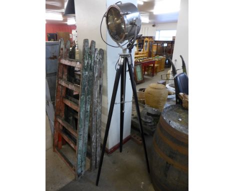 A chrome theatre style spotlight on a tripod base
