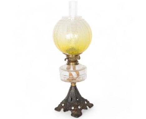 Victorian oil lamp with yellow glass shade, moulded glass font and pierced cast-iron plinth, with chimney, height overall 55c