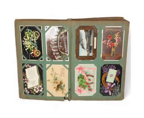 A fully stocked Vintage postcard album, containing a variety of postcards, including greetings cards, Christmas postcards, bi