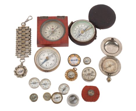 A group of Vintage miniature compasses, including a leather-cased 