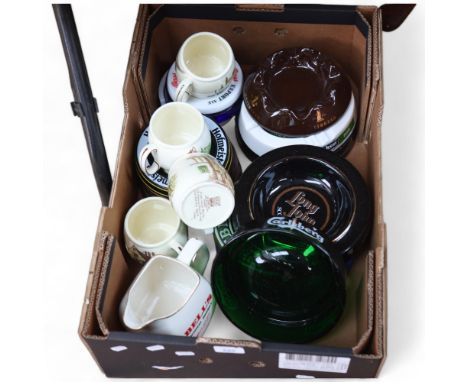 A quantity of pub related ceramic items, including various ashtrays and jugs, advertising various brands, including Carlsberg